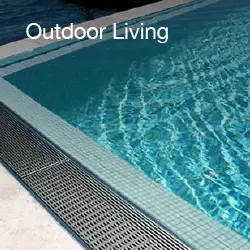 Outdoor living space featuring a linear drain system by the pool